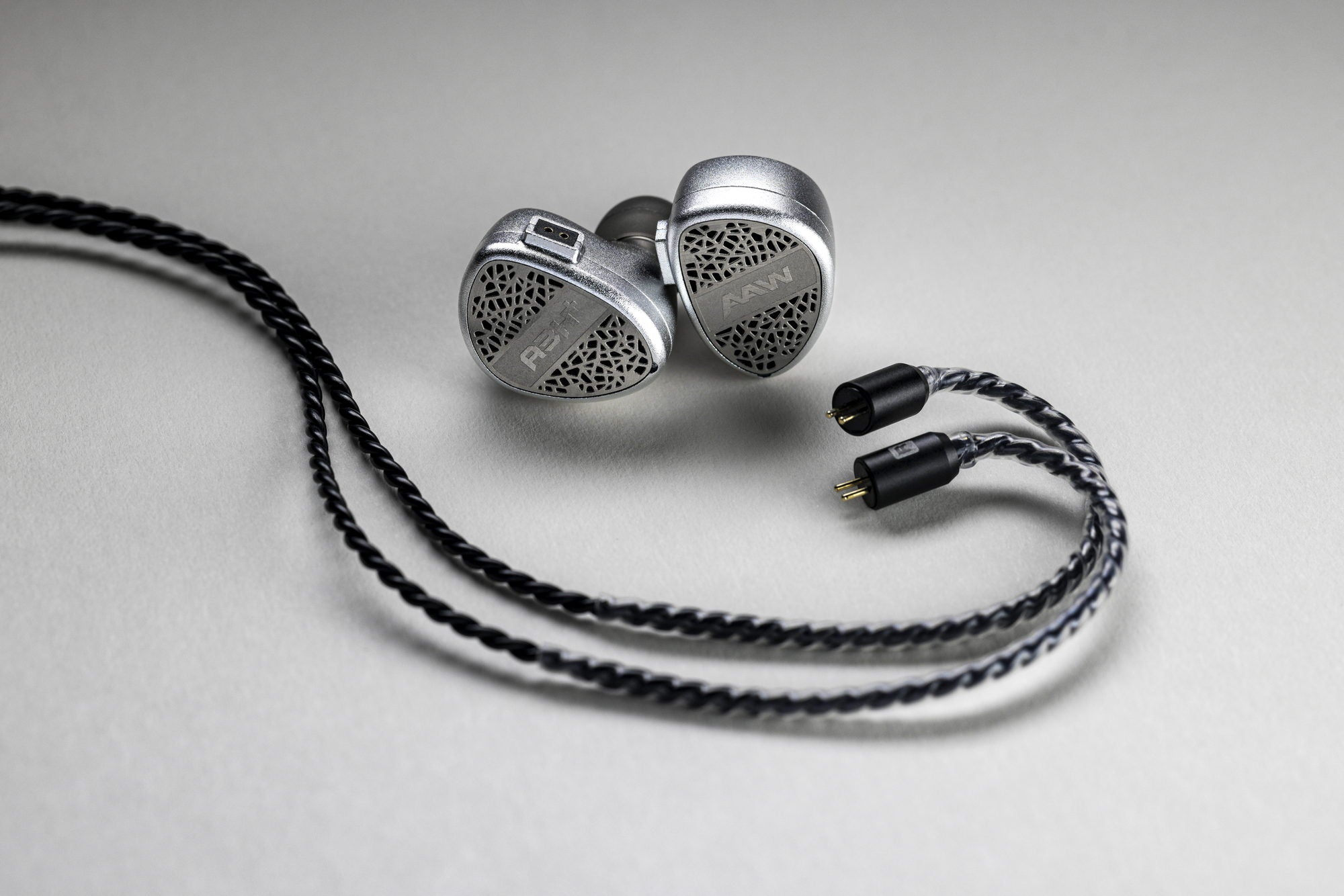 A3H+ Lux universal monitors and cable on a neutral studio surface