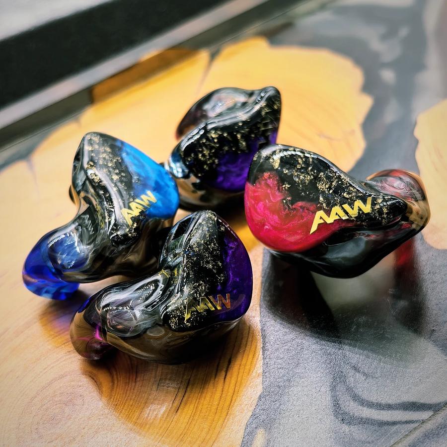 AAW custom in-ear monitors arranged in a shell color and faceplate display