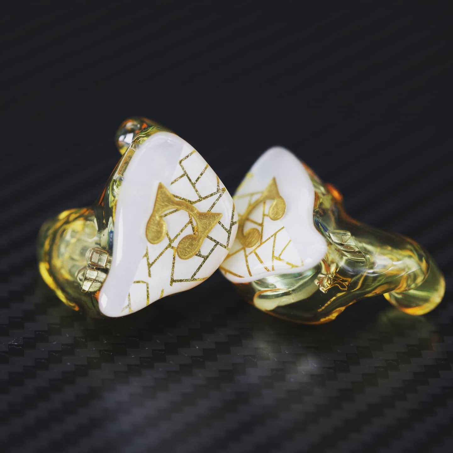 AAW ASH custom in-ear monitors with white and gold musical motif faceplates