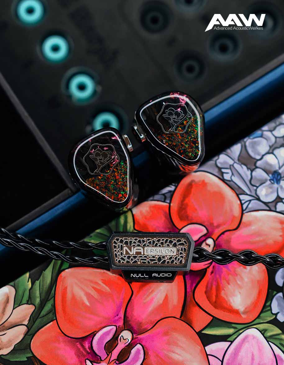 Black Malus monitors with opal faceplates and Null Audio Epsilon cable over floral artwork