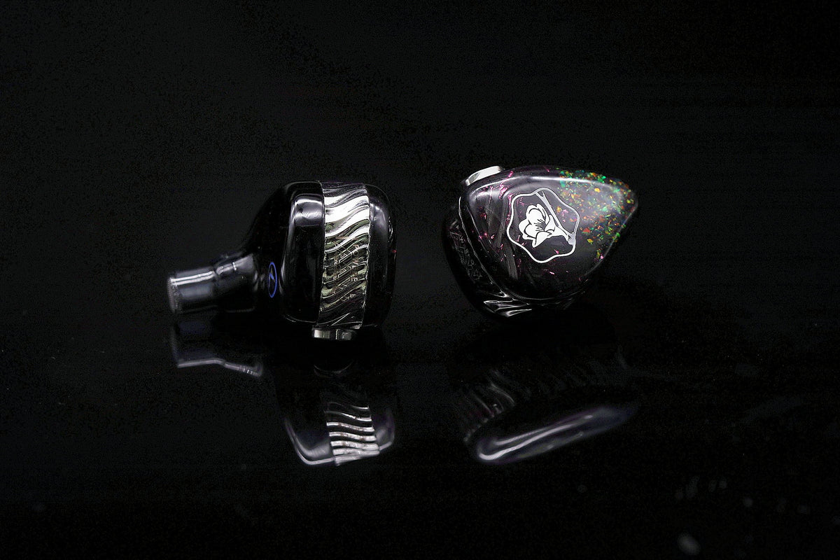 Black Malus monitors with opal faceplates on a dark studio background