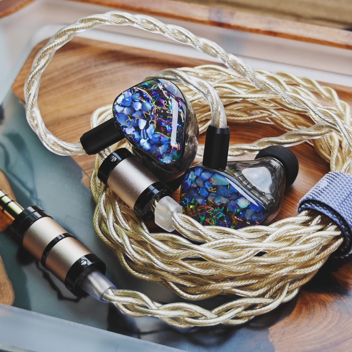 Canary Pro connected to a cable and player with blue faceplates on a wooden surface