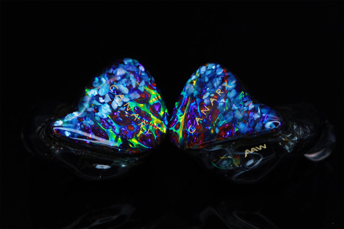 Custom-fit Canary Pro pair showing blue iridescent faceplates and clear shells