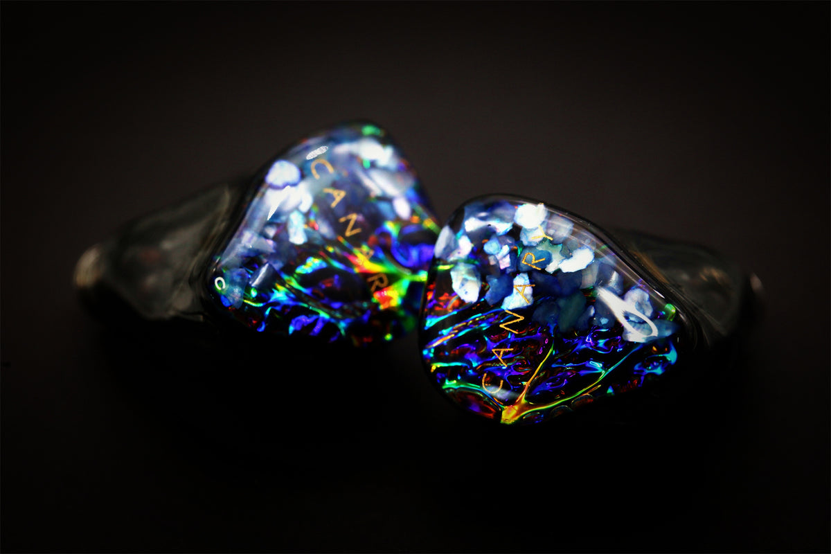Angled Canary Pro faceplates glowing blue and green under studio light