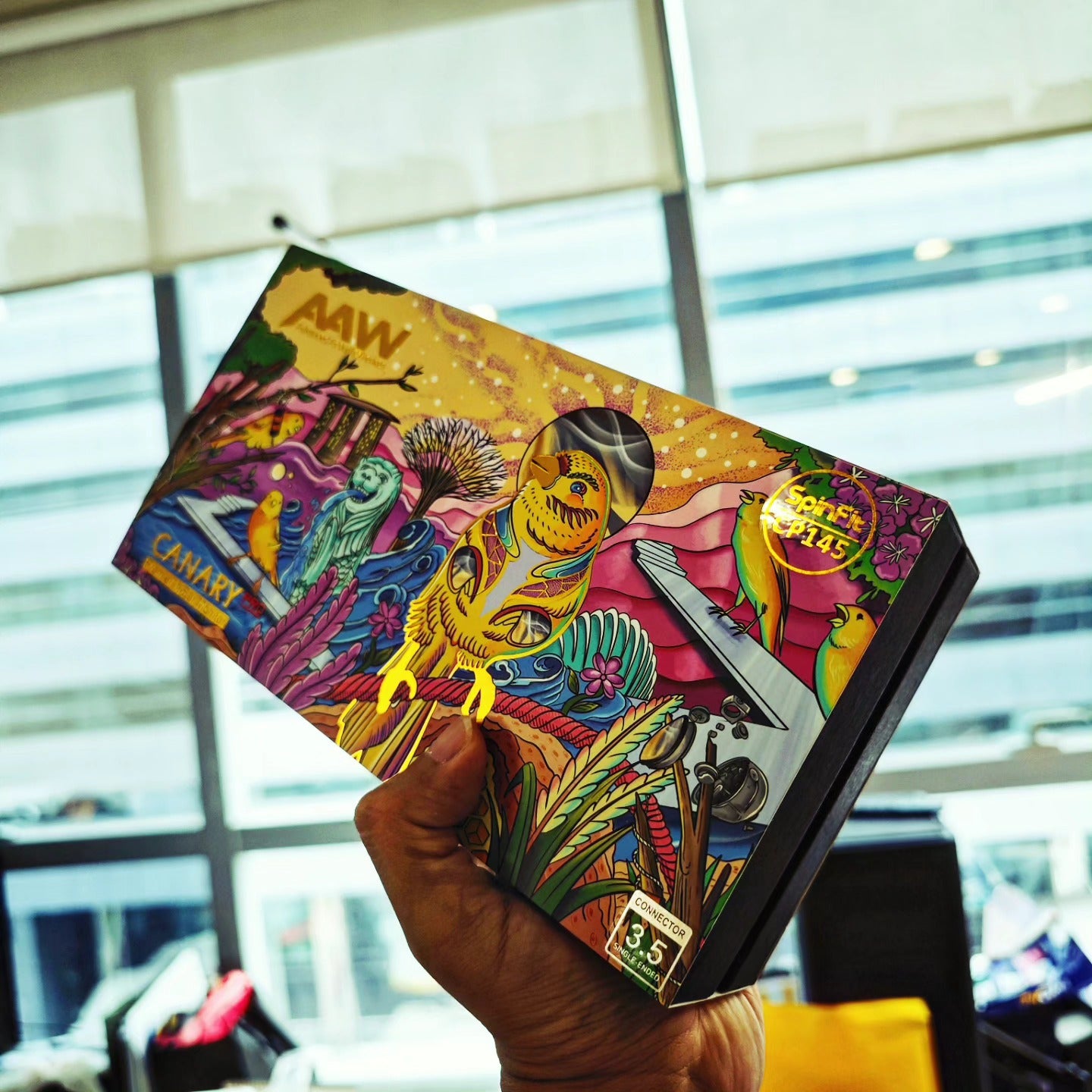 Canary Pro illustrated packaging held in Singapore with Merlion, skyline, orchid, and canary identity artwork